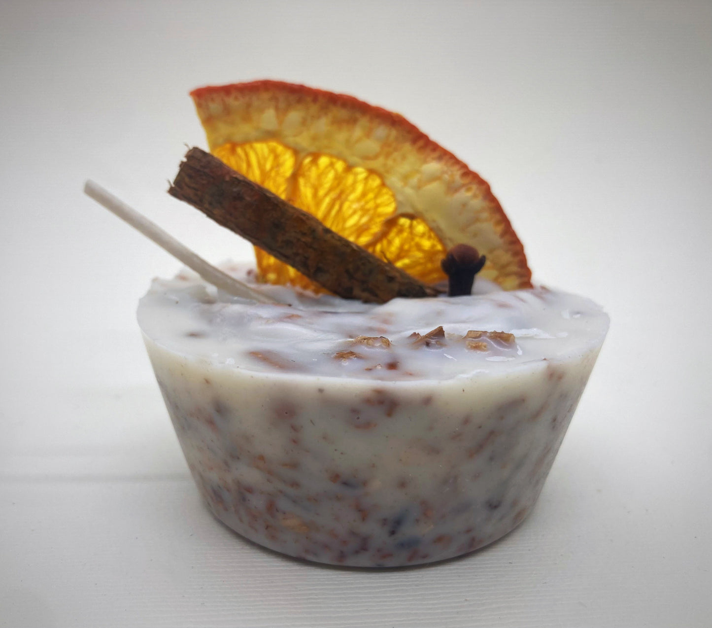 fire starters made from recycled wood shavings wax and essential oil decorated with orange and cinnamon